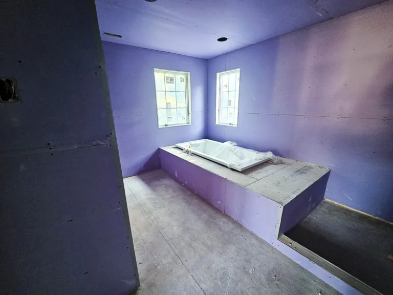 a room with a bathtub and windows