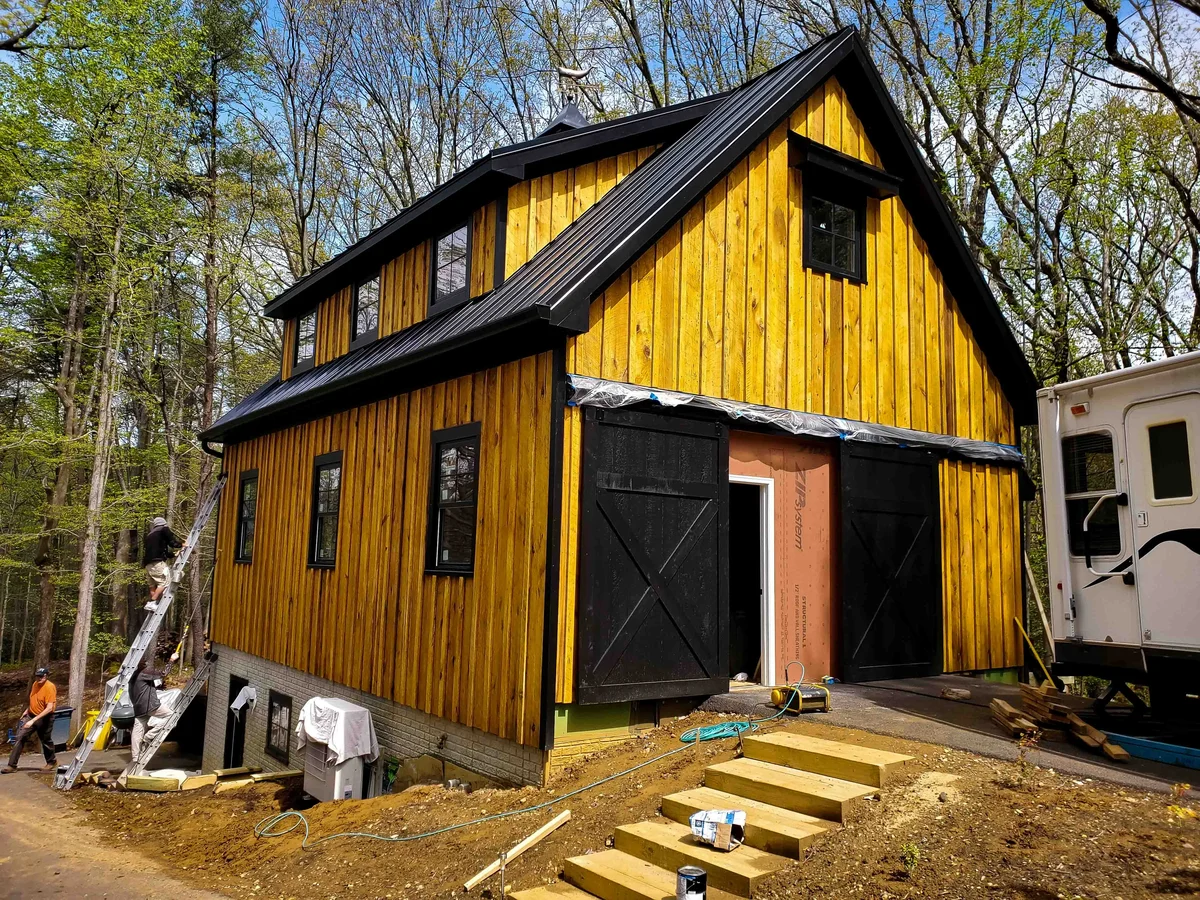 a yellow house with black trim